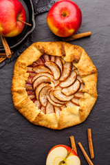 Baked galette or open pie with apples on the table