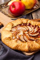 Baked galette or open pie with apples on the table