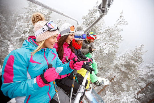 Friends in ski lift on mountain