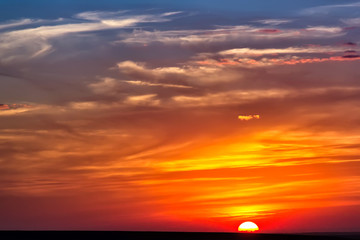 Minimalist cloudy colorful sunset over the hills, Dobrogea, Romania