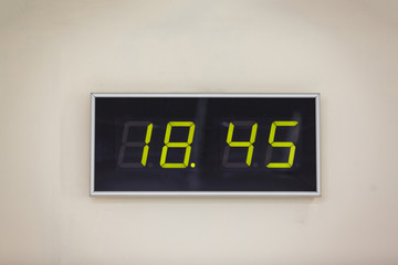 Black digital clock on a white background showing time 18 hours 45 minutes