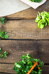 Parsley in a basket on a wooden background.