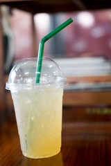 Ice green tea with lemon and honey in takeaway glass