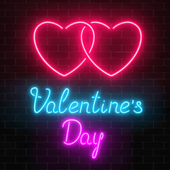 Happy Valentines Day neon glowing festive sign on a dark brick wall background.
