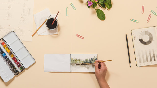 Overhead shot of a woman creating a watercolor