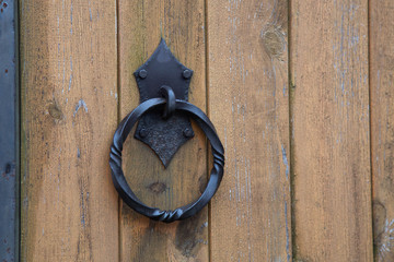 wooden gate fence and a door with forged elements