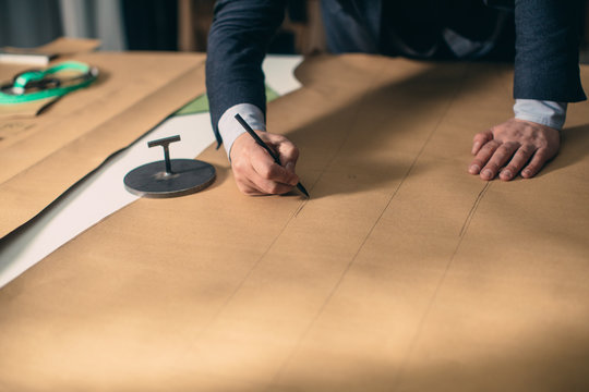 Tailor Working With Clothes Patterns