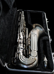 Silver saxophone in its case