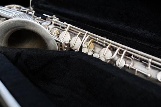 Silver saxophone in its case