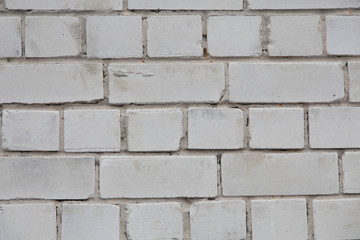 texture brick wall of white color with cracks on the surface