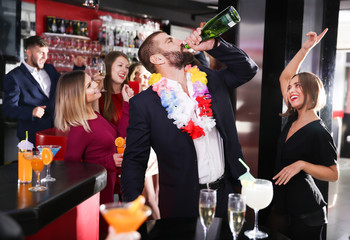 Man drinking too much on Hawaiian party