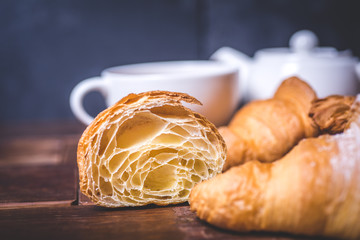 A close-up of a cut croissant on the table.