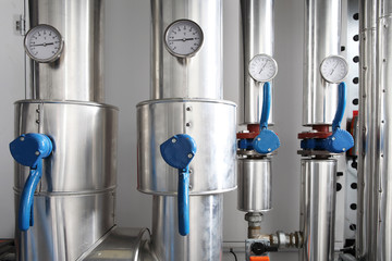 manometer, pipes and faucet valves of heating system in a boiler room