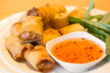 Fried spring rolls with sauce.