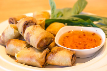 Fried spring rolls with sauce.