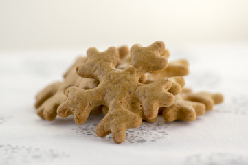 Traditional tasty Czech gingerbreads, Christmas snowflakes on white tablecloth with hearts and stars