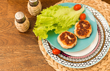 Juicy homemade cutlets (beef, pork, chicken) on a wooden background. The concept of a healthy diet.