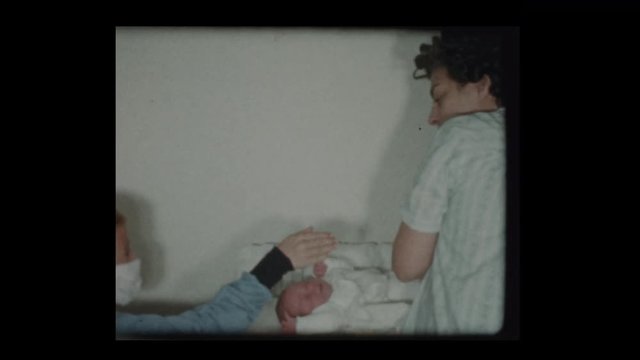 1959 Mother and son change newborn baby diapers