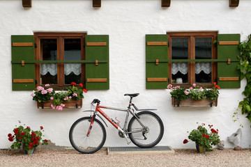Fototapeta na wymiar Sport bicycle against typical german country house wall