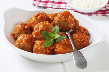 Turkey meatballs in tomato sauce with a spoon.