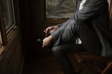 Young Man putting on shoes in suit