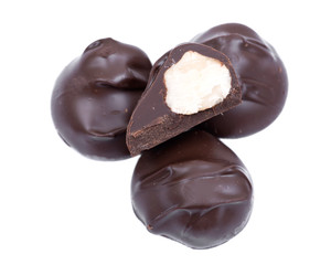 Dark chocolate covered  macadamia nuts isolated on white background