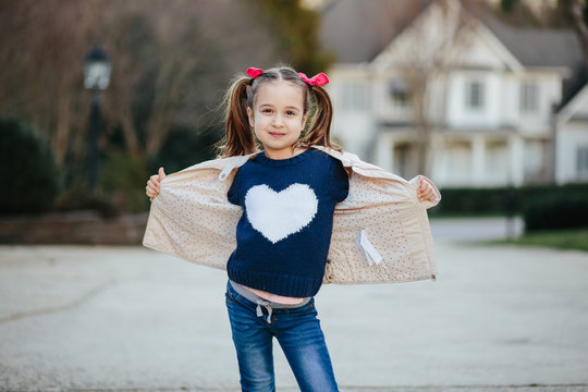 Portrait of a girl wearing a blue sweater with white heart shape on it