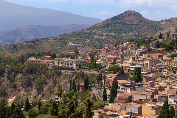 Fototapeta premium Taormina, Sicily, Italy. The historic city center in the background of the mountains