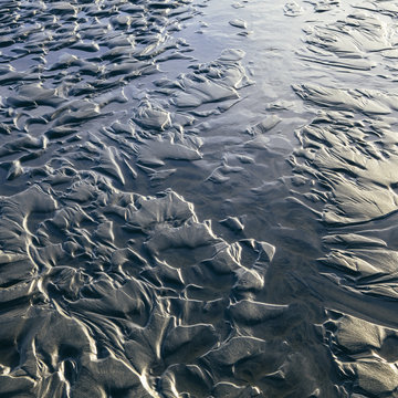 Detail of patterns in sand at low tide