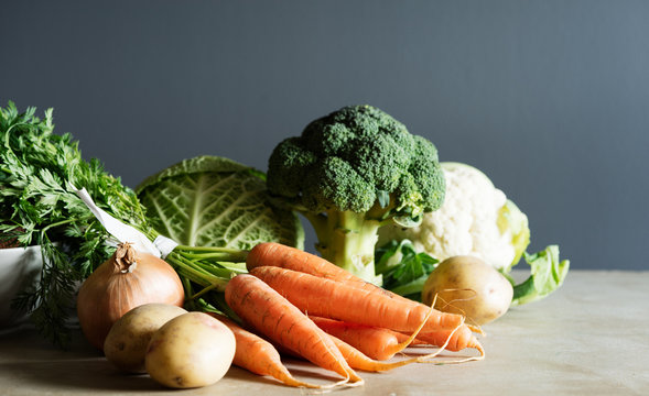 Group of fresh vegetables on a counter top.