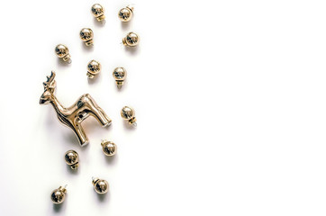 Christmas composition with a deer and Christmas balls on a white background. Christmas background for presentation of work or text. Beautiful greeting card.Top view. Copy space