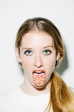 Female with sprinkles on tongue