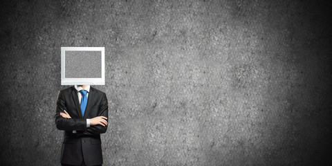 Businessman with monitor instead of head.