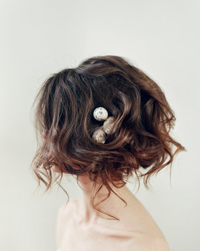 Woman with eggs in hairdo