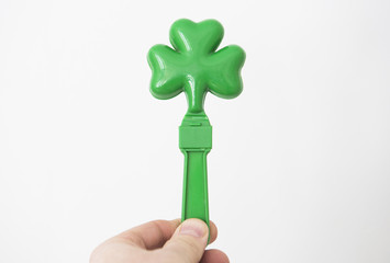 A man holds a plastic shamrock to celebrate Saint Patrick's day