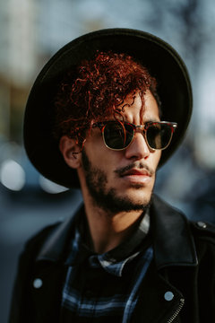 Man wearing black leather jacket and hat