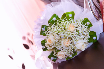 White wedding and engagement flower bouquet. Beautiful wedding bouquet with different flowers, roses. wedding rings and wedding details