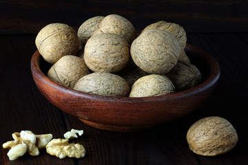 Walnut in wooden plate.