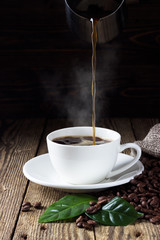 Pouring coffee in cup