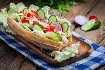 Homemade sandwich on a wooden table.