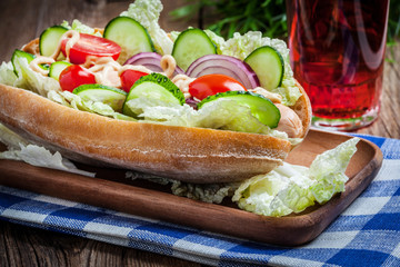 Homemade sandwich on a wooden table.