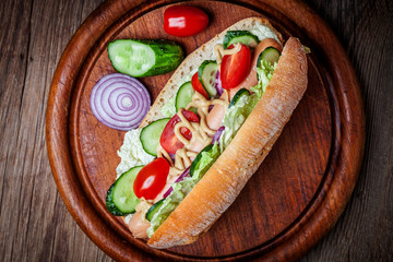 Homemade sandwich on a wooden table.