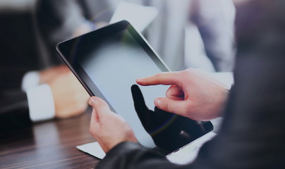Businessman holding digital tablet at meeting