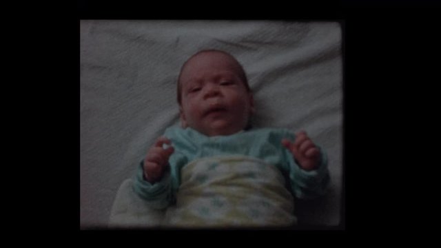 1959 Fidgeting 2 month old infant boy in crib