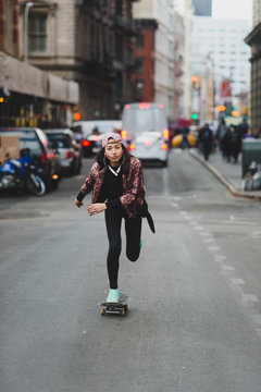 Young woman skating in the city