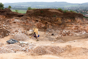 Lugazi, Uganda. June 18 2017. Ugandan women breaking rocks in a quarry.
