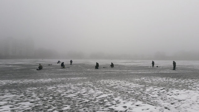 The fishermen on a frozen water
