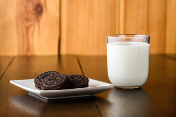 some chocolate cookies and a glass of milk - obrazy, fototapety, plakaty