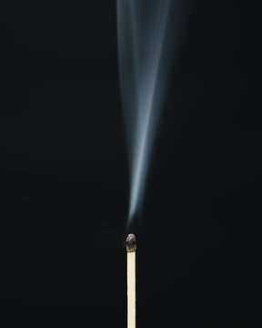 Close up of smoke rising off lit match
