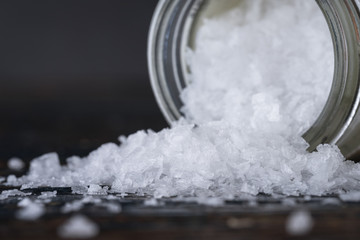Sea Salt Flakes Spilled from a Spice Jar